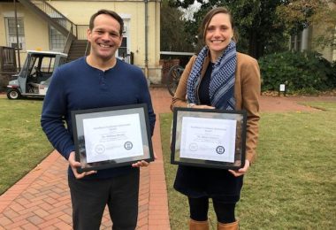 Dr. Will Bryant and Dr. Blaire Zeiders stand holding awards
