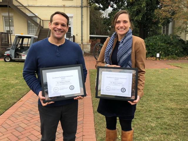 Dr. Will Bryant and Dr. Blaire Zeiders stand holding awards